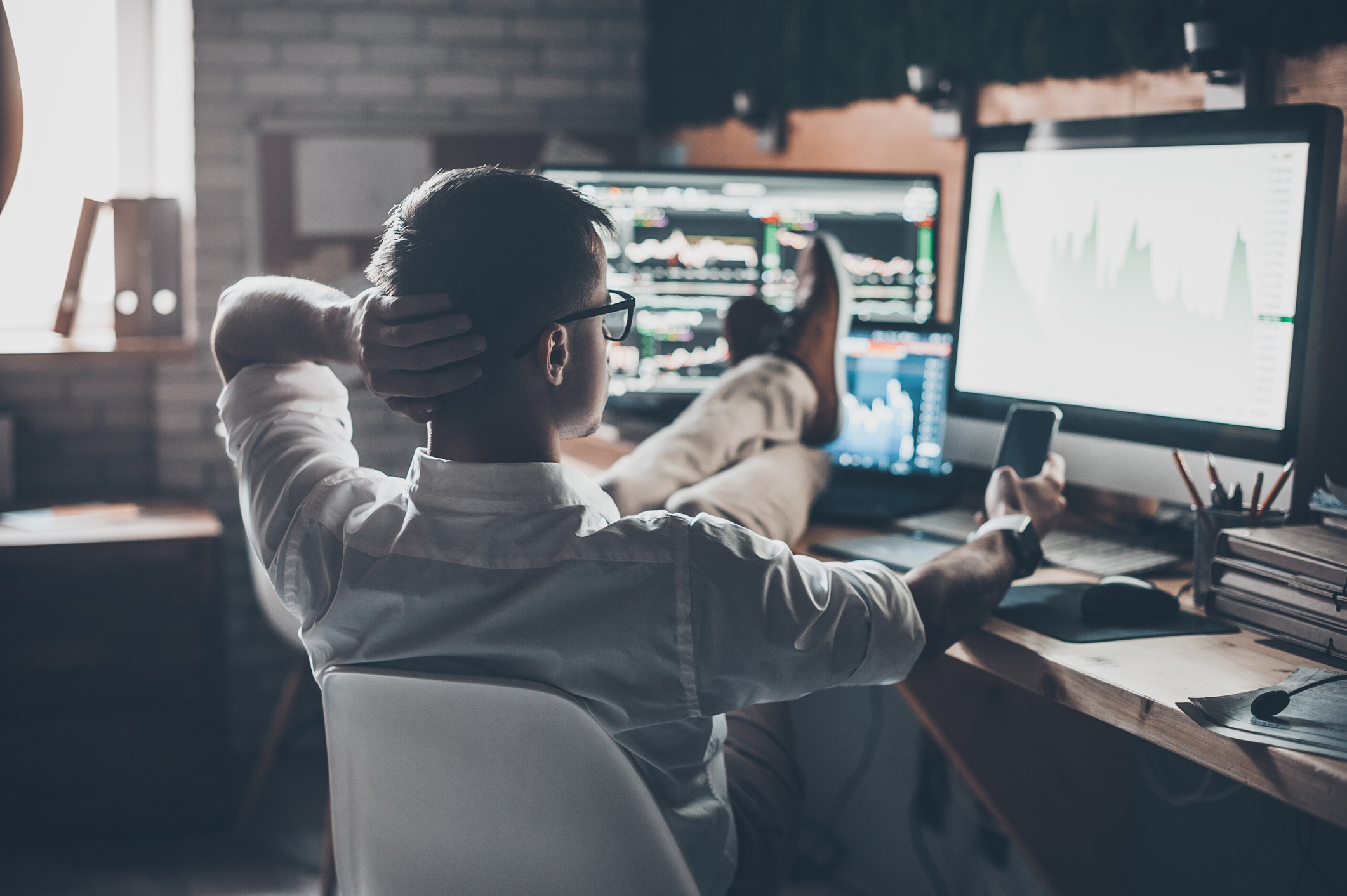 Professional trader watching at screens with trading charts | AfterPullback